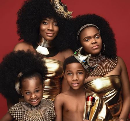 yandy with all her 3 children in a gold outfit 